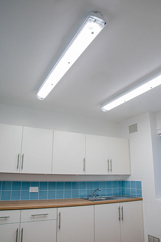 A photo of a kitchen with the light on