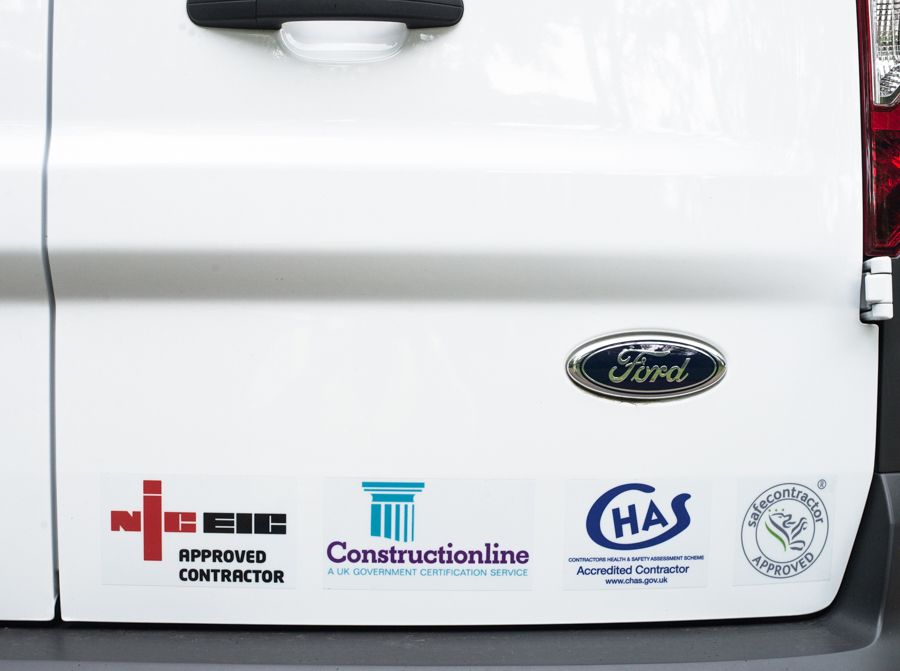 The back of an AMS Electrical van showing the logos: NICEIC, Constructionline, CHAS and safe contractor
