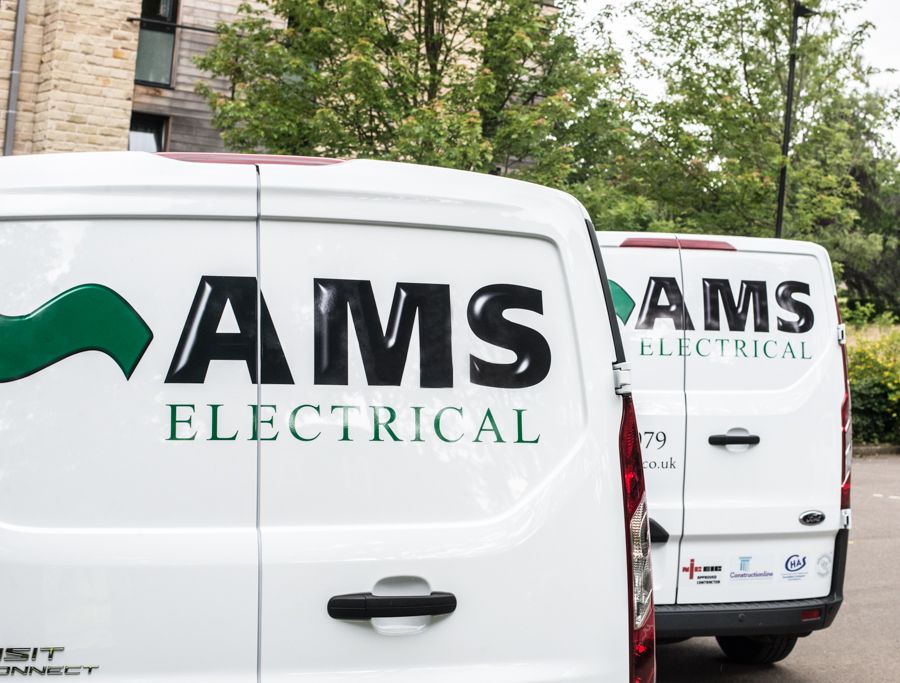 The back of two AMS Electrical vans lined up
