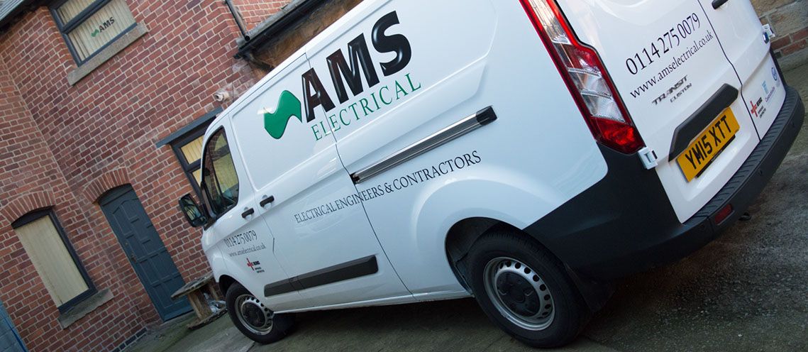 A side shot of an AMS Electrical van